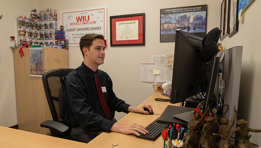 Dillon at his desk in the Welcome Center