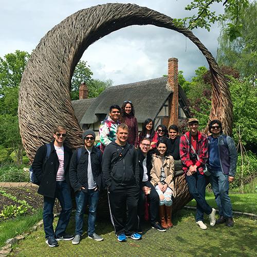 Theatre arts study abroad students in London standing in front of a sculpture