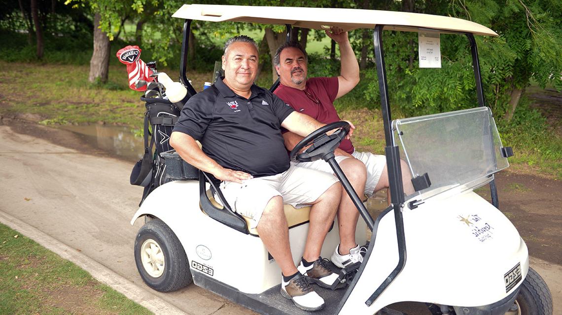 golfers in golf cart