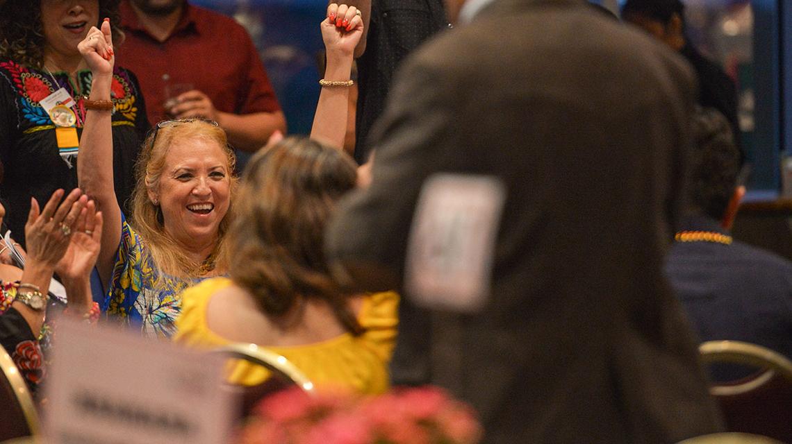 woman excited smiling with hands up