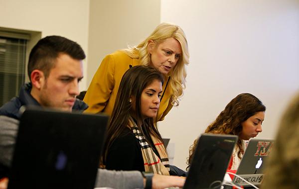 Instructor and student on a laptop