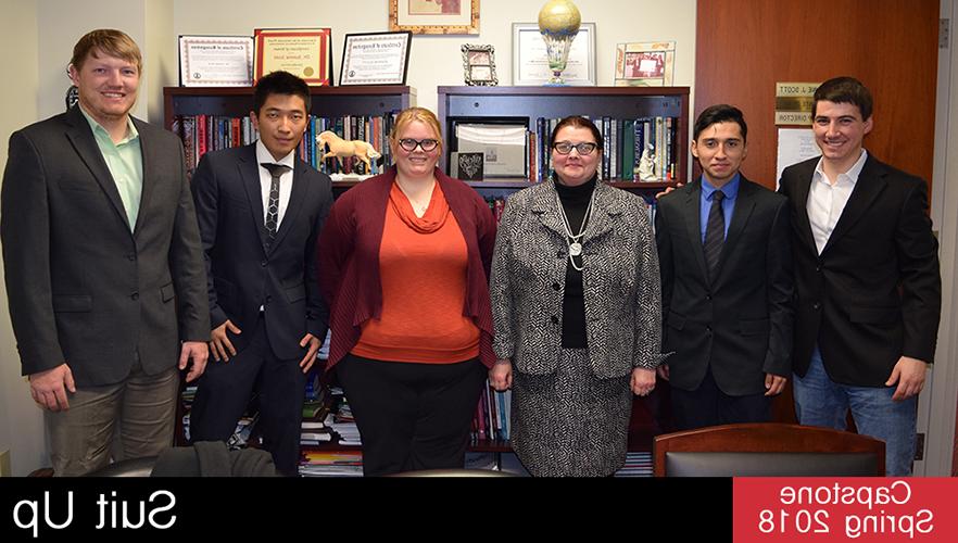 capstone students pose with suit up client