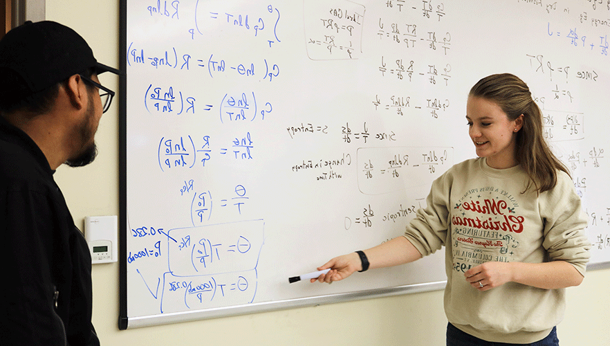 2 meteorology students working math equations