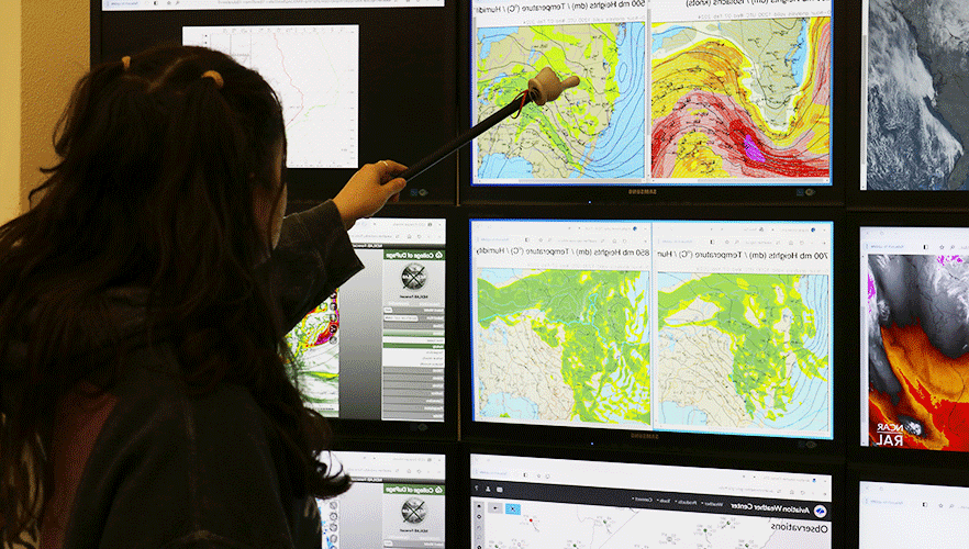 Meteorology student looking at monitor